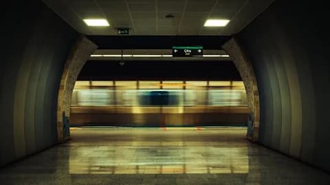 Motion-blurred train speeding through a subway station